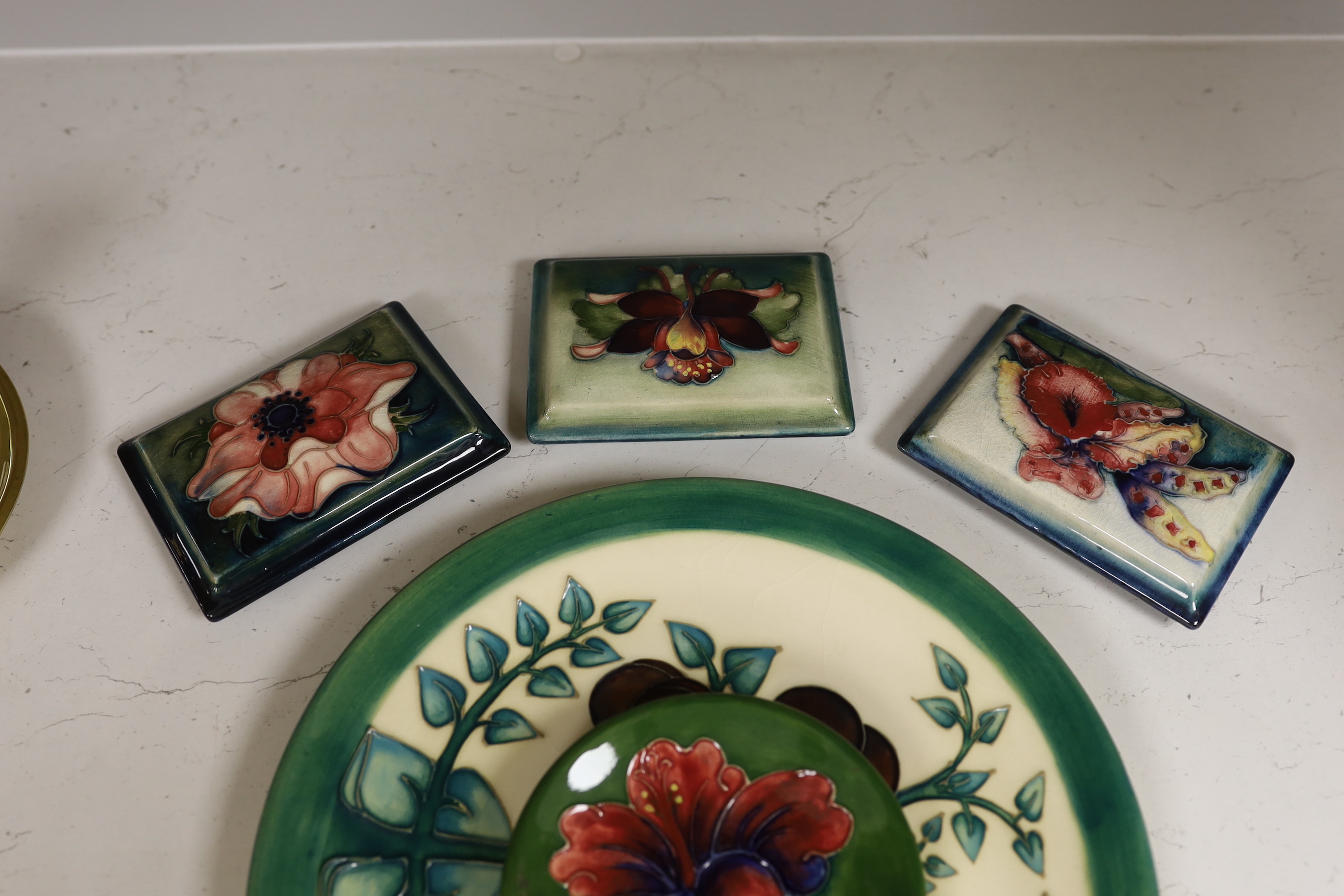 Three Moorcroft box lids, a pin dish and a larger dish (5)